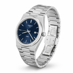 Tissot Best PRX stainless steel watch with a blue dial and silver link bracelet, shown on a clean white background.